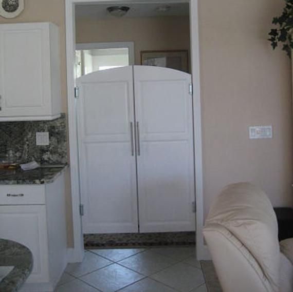 a white refrigerator freezer sitting inside of a kitchen next to a counter top oven