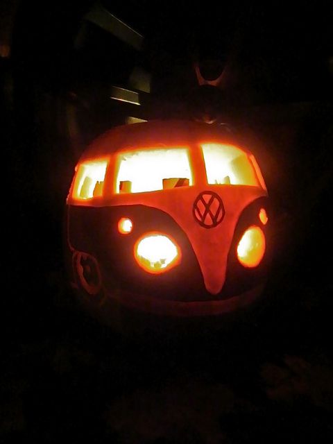 a vw bus pumpkin carved to look like it is lit up in the dark