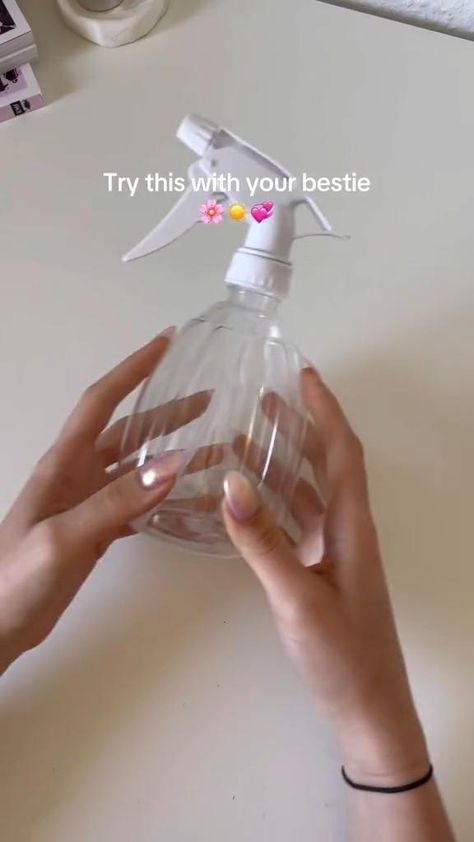 someone is holding a hand sanitizer in front of a white table with the words try this with your bestie on it