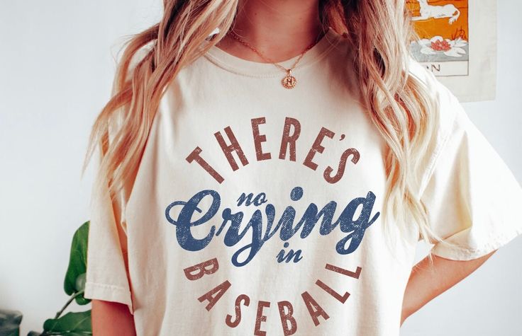 **There's No Crying in Baseball T-Shirt** Embrace the spirit of America's favorite pastime with our "There's No Crying in Baseball" T-Shirt. Perfect for game days, practices, or casual outings, this shirt is a must-have for any baseball fan who loves to show their passion for the sport. ### Key Features: - **Premium Material Crafted from high-quality, soft, and breathable fabric, ensuring maximum comfort during any activity. - **Iconic Design Features the classic phrase "There's No Crying in Baseball," inspired by the famous movie quote, making it a standout piece for any fan. - **Comfortable Fit Designed with a relaxed fit that flatters all body types, making it ideal for everyday wear. - **Durable Print High-quality print that remains vibrant and intact even after numerous washes. - **Ve Casual T-shirt With Lettering For Game Day, Graphic Tee With Lettering For Game Day, Cotton T-shirt With Baseball Season Lettering, Sports T-shirt With Lettering And Short Sleeves, Sports Fan Cotton Tops With Lettering, College Sports Fan T-shirt With Lettering, Graphic Tee With Sports Lettering For Events, Graphic Tee With Lettering For Sports Events, Graphic Tee With Sports Lettering