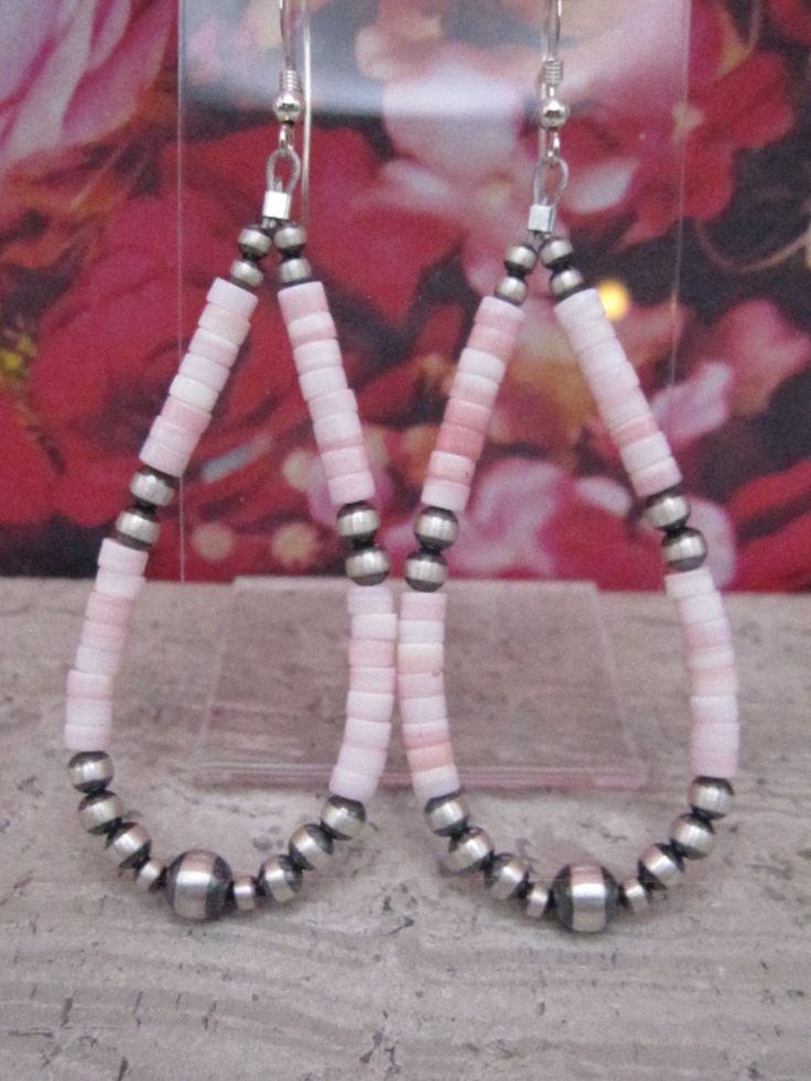 Pink conch and Navajo Pearls are so hot this year!  While the beads on these earrings are machine made they are sterling silver and super cute when combined with the pink conch beads.  The oxidized finish give these earrings a traditional feel while the pink conch feels very contemporary and feminine.  The earrings dangle approximately 3" in length.  These are really very beautiful earrings.  There is also a matching necklace in The Turquoise Badger store.  If you are not satisfied with your pur Silver Southwestern Beaded Earrings With Ear Wire, Southwestern Silver Beaded Earrings With Ear Wire, Southwestern Beaded Drop Earrings For Pierced Ears, Handmade Southwestern Dangle Teardrop Earrings, Southwestern Style Beaded Drop Earrings, Handmade Southwestern Teardrop Dangle Earrings, Handmade Pink Southwestern Jewelry, Southwestern Nickel-free Teardrop Earrings, Southwestern Dangle Hoop Earrings As Gift