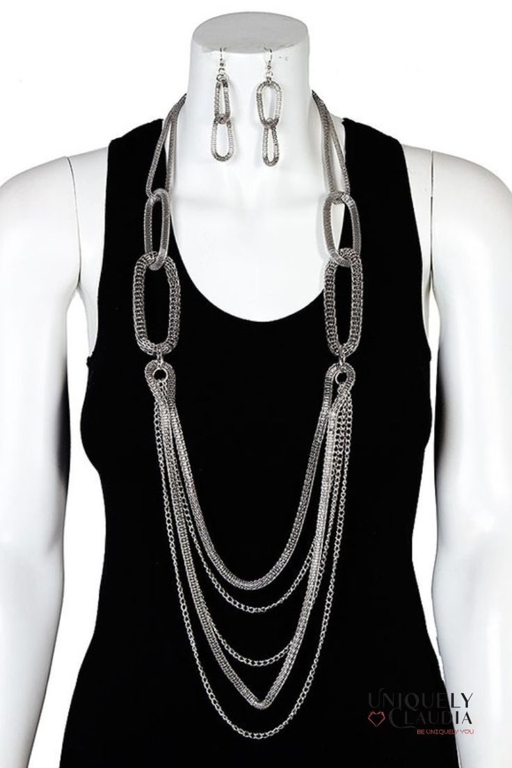 Elevate your accessory game with the Lizette Long Layer Oval Earrings & Necklace Set – a statement piece that effortlessly combines customization, style, and impeccable craftsmanship. Redefine your jewelry collection with this versatile set that transitions effortlessly from day to night, making every occasion a moment to shine. Available in both silvertone and hematite tone options, this set is a versatile choice that effortlessly combines sophistication with contemporary flair. The star of the Silver Oval Pendant Chain Jewelry, Oval Costume Jewelry For Parties, Silver Oval Chain Jewelry, Elegant Jewelry Sets With Adjustable Chain, Metal Chain Necklace With Oval Pendant, Silver Oval Pendant Costume Jewelry, Elegant Silver Long Necklace Jewelry Set, Trendy Oval Jewelry For Formal Occasions, Trendy Oval Chain Jewelry