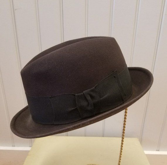 This iconic fedora hat is in excellent vintage condition: I can find no flaws other than on the cream silk satin lining which is soiled.  The lining is stamped:  Lock & Co. Hatters, St. James Street, London, Established 1759, Registered Trademark.As per Brooks Brothers:  "As the oldest hat shop in the world, Lock and Co. Hatters has provided headwear for men of distinction since 1676. From their home on St. James's Street in London, Lock and Co. serves a client base that includes His Royal Highn Formal Brown High Crown Hat, Vintage Fedora With Wide Brim, Vintage Fitted Fedora With Flat Brim, Retro Fedora With Short Brim For Formal Events, Retro Fedora With Short Brim For Formal Occasions, Fitted Vintage Fedora With Wide Brim, Vintage Wide Brim Fedora, Retro Short Brim Fedora For Formal Events, Retro Short Brim Fedora For Formal Occasions