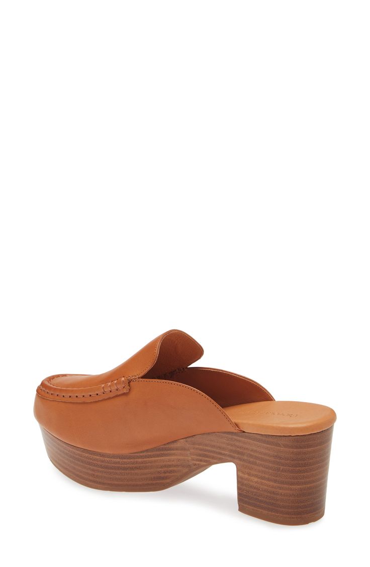 A moc toe and loafer-inspired topline add sophisticated elements to a leather mule lofted by a chunky platform and block heel. 3" heel; 1 1/4" platform Cushioned footbed Leather upper and lining/rubber sole Imported Chic Platform Slippers With Leather Footbed, Brown Slip-on Platform Loafers With Removable Insole, Classic Mules With Wooden Heel For Work, Chic Round Toe Platform Slippers With Leather Footbed, Modern Brown Leather Clogs, Chic Platform Slippers With Leather Footbed And Round Toe, Chic Leather Closed Toe Platform Slippers, Chic Leather Platform Slippers With Closed Toe, Modern Brown Mules With Round Toe