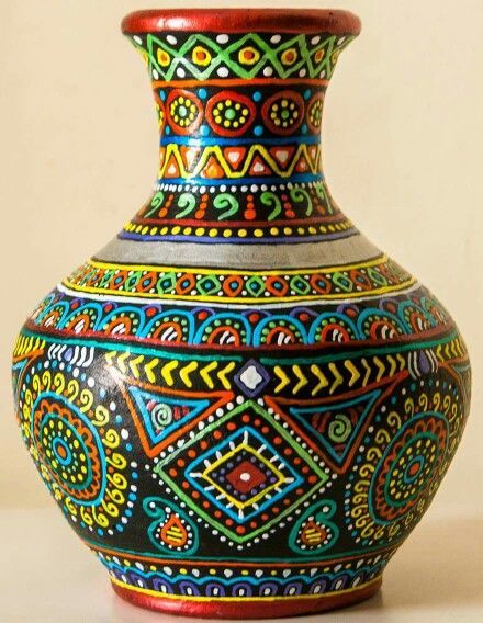 a colorful vase sitting on top of a table