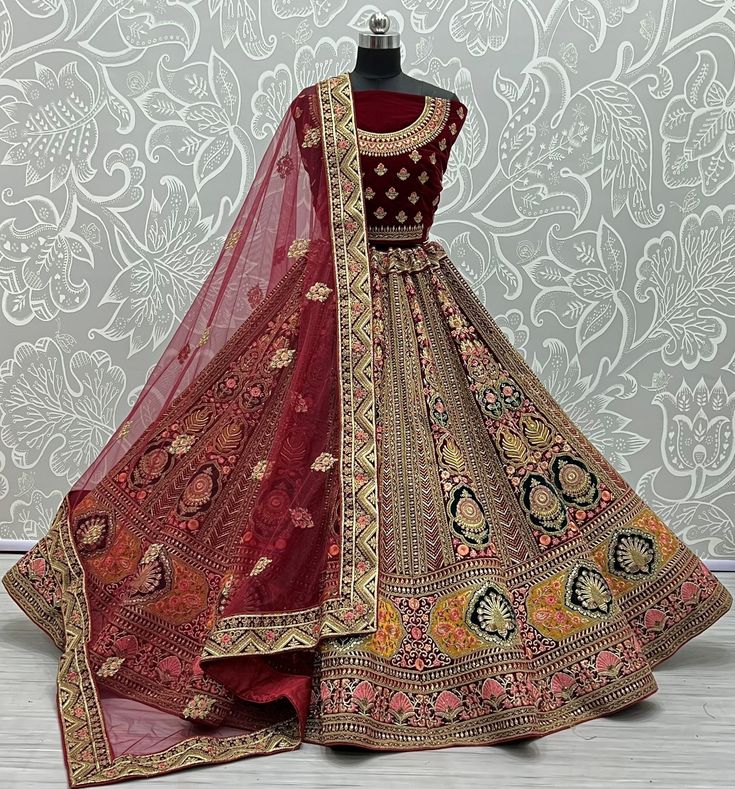 Outstanding designer bridal lehenga choli  Code : A2339 Lehenga : Fabric - velvet  Work - dori embroidery               Patch work               zari work and zircon diamond               Thread embroidery  Stitching - standard cancan and canvas attached  Size - free size up to 42 Blouse :  Fabric - velvet  Work - four side lace and butti work  Size - 1.2 meter long unstitched  Backside work - yes  Dupatta : Fabric - soft net  Work - four side lace and butti work  Size - 2.5 meter long  Weight - Red Heavy Lehenga For Festive Occasions, Heavy Red Lehenga For Diwali, Red Embellished Bollywood Lehenga, Heavy Red Lehenga For Reception, Red Embellished Lehenga For Festive Occasions, Heavy Lehenga For Diwali, Bollywood Style Heavy Lehenga For Festivals, Heavy Lehenga For Diwali Festivities, Heavy Bollywood Lehenga For Festivals