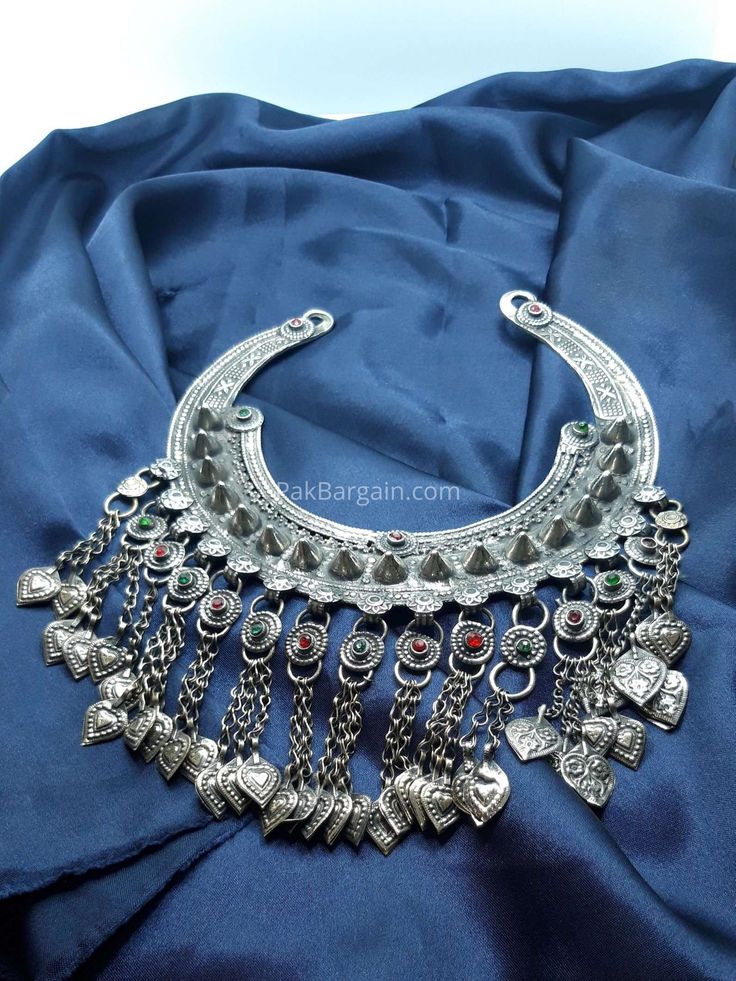 * This tribal necklace is a stylish and trendy antique craft, handpicked for its classic design and antiquity. * It is crafted with metal alloy and covered with rustic silver hues. Its chord is embellished with finely carved patterns and the bottom has long dangling tassels, flaunting all the tribal vibes. Its rustic classic vibes are making it a classic ornament, light in weight and easy to style. * It is a chunky traditional craft, good to go with any traditional or modish attire. Let us take Classic Ornament, Torque Necklace, Necklace Vintage, Choker Necklaces, Jewelry Vintage, Vintage Necklace, Boho Jewelry, Classic Design, Choker