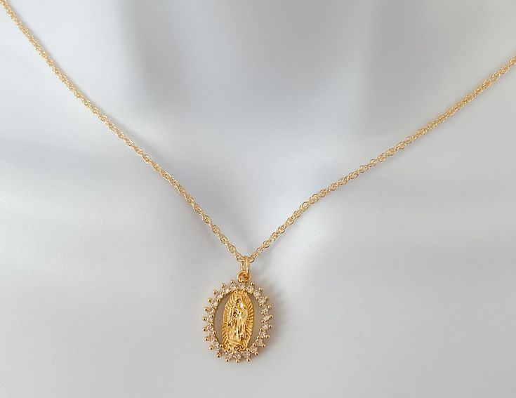 Our lady of Guadalupe necklace MATERIAL AND SIZE 18k gold plated medal 18k gold filled cable chain Cubic zirconia Size pendant: 2cmx1cm Length chain: 45cm If you have questions about the product, feel free to reach me out. Don't forget to check out my other items in the store: Https://www.etsy.com/shop/nyahwithlove Miraculous Medal Pendant Jewelry For Wedding, Miraculous Medal Wedding Pendant Jewelry, Wedding Miraculous Medal Pendant Jewelry, Oval Our Lady Of Guadalupe Necklace For Gift, Oval Our Lady Of Guadalupe Necklace Gift, Spiritual Jewelry: Our Lady Of Guadalupe Round Pendant, Spiritual Oval Our Lady Of Guadalupe Necklace, Spiritual Oval Necklace Featuring Our Lady Of Guadalupe, Spiritual Virgin Mary Medallion Jewelry