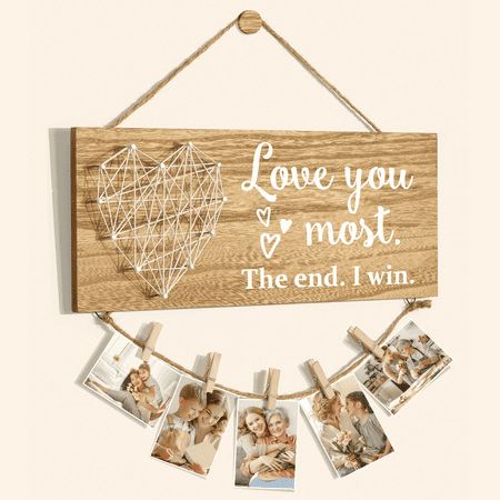 a wooden sign hanging from a rope with photos on it and the words, grandkids are close to the heart