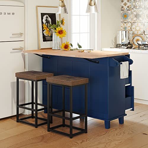 a kitchen island with two stools in front of it and sunflowers on the counter