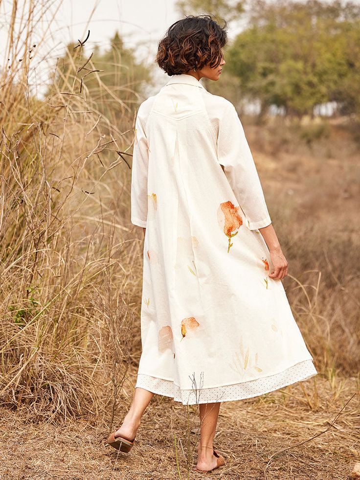 VALUES Handcrafted Organic Fair Minimal Waste CURATOR'S NOTE An off white breezy dress, crafted from breathable cotton mul fabric, adorned with a delicate floral print featuring a polka printed lining that gives the perfect fall. The dress comes with side seam pockets for added convenience. THE DESIGNER STORY KHARA KAPAS, meaning 'pure cotton' in Hindi, started with the belief that design is a form of expression. True to its name, the brand continuously strives to achieve purity through their fa Off White Cotton Dress For Garden Party, Spring Cotton Voile Day Dress, Spring Daywear Cotton Voile Dress, Spring Cotton Dresses For Daywear, White Cotton Voile Summer Dress, White Cotton Dresses For Spring, Spring Floral Print Cotton Voile Dress, Floral Print Cotton Voile Dresses, White Cotton Voile Dress