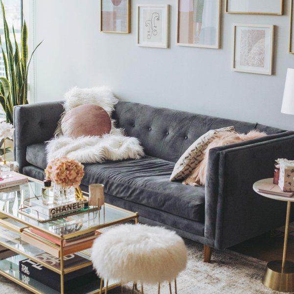 a living room filled with lots of furniture and pictures on the wall above it's glass coffee table