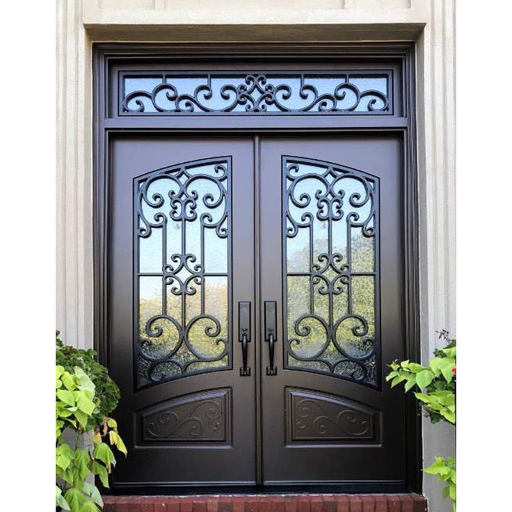 the front door to a home with wrought iron doors