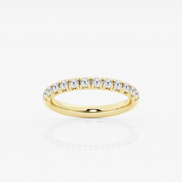 a yellow gold wedding band with five round diamonds on the top and bottom, set against a white background