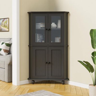 a living room with a couch, chair and tall cabinet in it's corner