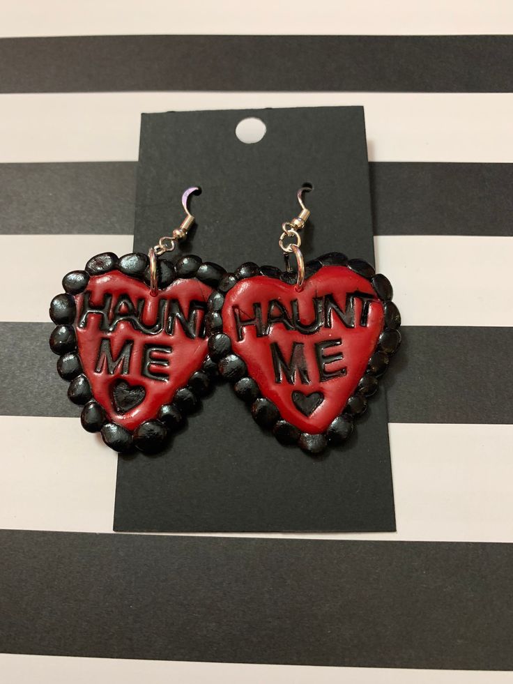 Valloween heart earrings that say Haunt me! Valentine's Day Heart Shaped Themed Jewelry, Valentine's Day Themed Heart Jewelry, Valentine's Day Heart-shaped Themed Jewelry, Gothic Dangle Earrings For Valentine's Day, Handmade Heart-shaped Novelty Earrings, Halloween Party Heart-shaped Earrings, Heart-shaped Halloween Party Earrings, Novelty Earrings For Valentine's Day Party, Novelty Earrings For Party On Valentine's Day