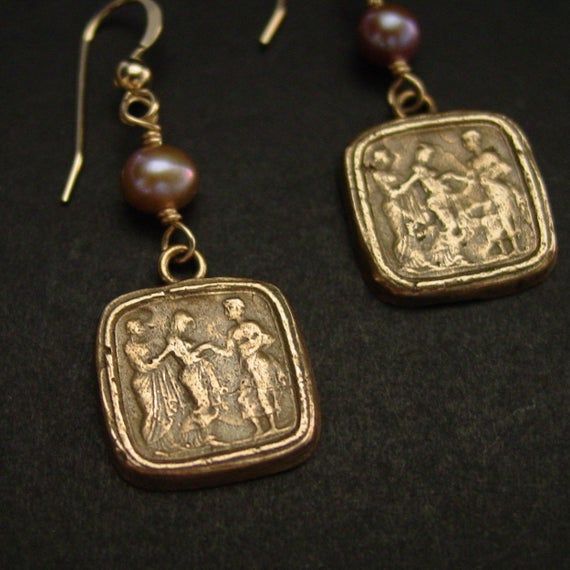 Handmade reproduction of intaglio earrings representing this great odyssey scene of Odysseus returning to his queen Penelope. The cameo represents Queen of Ithaca, Penelope, being led in secret by her lady in waiting to her husband, Odysseus, who went missing during the Trojan War.The Odyssey is a Greek epic poem traditionally attributed to Homer, describing the travels of Odysseus during his ten years of wandering after the fall of Troy. He eventually returned home to Ithaca and killed the suit Heirloom Engraved Earrings As Gift, Elegant Hand Cast Brass Earrings, Elegant Hand Cast Drop Earrings, Intaglio Drop Earrings For Gift, Artisan Hand Cast Earrings As Gift, Odysseus And Penelope, His Queen, After The Fall, Tarpon Springs