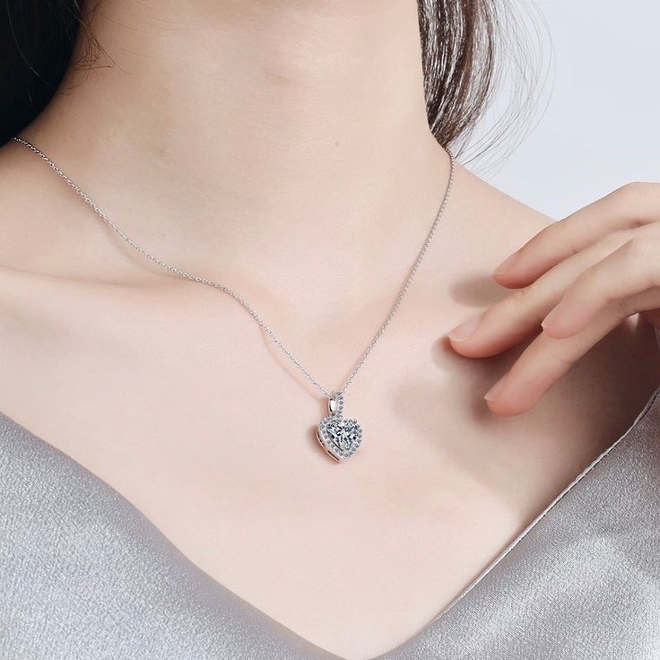 Delicate and elegant, this heart necklace will add a touch of sophistication to any wedding gown or formal ensemble. Adorned with heart-shaped cubic zirconia that captures the light from every angle with a perfectly translucent appeal, the necklace is rhodium / rose gold plated for a flawless finish which perfectly enhances the intricate detailing and conveys a modern take on old elegance. Length: 16" (approx. 40.6cm) with a 2" (approx. 5cm) extension for comfortable sizing. Available in Silver Sparkling Wedding, Anniversary Necklace, Sparkle Wedding, Wedding Party Jewelry, Charm Pendant Necklace, Necklace Dainty, Diamond Pendant Necklace, Bridal Necklace, Forever Love