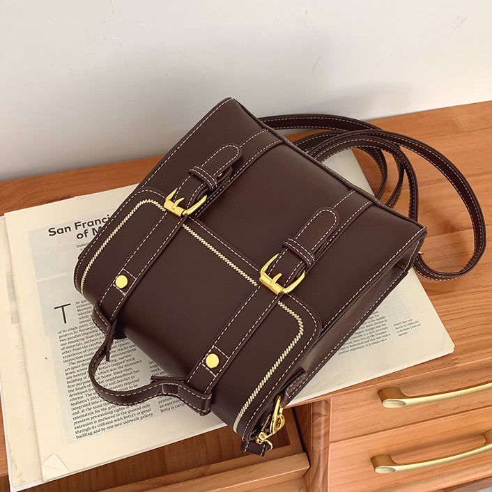 Faux leather boxy satchel bag with adjustable buckle and detachable straps that allows it to be carried as a backpack or crossbody shoulder bag. Magnetic closure with zip up main compartment. 21cm x 21cm x 10cm 8.26" x 8.26" x 3.93" Square Satchel With Hasp Closure For School, Square Box Bag With Detachable Strap For School, Square Satchel With Zipper Closure For School, Leather Satchel Backpack With Hasp Closure, Square School Satchel With Zipper Closure, Square Shoulder Bag With Hasp Closure For School, Leather Shoulder Backpack With Hasp Closure, Trendy Rectangular Satchel With Buckle Closure, Rectangular Satchel With Adjustable Strap For Students