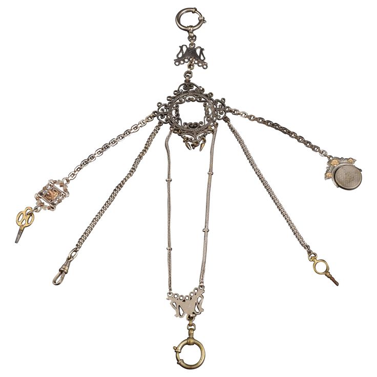 Leontina, late 19th century. Leontine made up of six chains attached to a ring decorated with scrolls and small earrings, from which a series of objects and hooks for small items hang. The two longest ones end in an openwork plate with a ring for the watch. This type of "jewelry" was very common in the upper class, to carry pocket watches, the keys required for their operation and other small valuables." Size: 32 long. 34 cms. ancho. Steampunk Hat, Pocket Watches, Watch Chain, The Keys, Small Earrings, A Series, 19th Century, Two By Two, Pendant Necklace