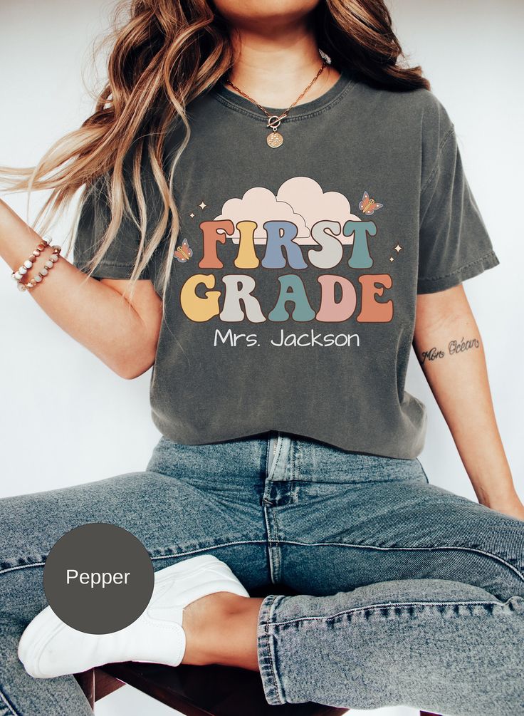 This Personalized First Grade teacher shirt is the ideal gift for a 1st grade teacher who loves their job. So if you are looking for a unique gift for a friend or family member then this tee is perfect. Our T-shirts are printed in the highest quality inks and the material is extremely comfortable. 5 COLORS TO CHOOSE FROM, SEE COLOR CHART 7 SIZES AVAILABLE: S-4XL  If you look at the listing photos, you will see some of the colors this shirt comes in, I have chosen the colors that I feel the shirt Personalized Short Sleeve T-shirt For Back To School, Cute T-shirt With Name Print For Teacher Appreciation, Personalized Casual Tops For Teacher Appreciation, Cute Tops With Name Print For Teacher Appreciation, School Spirit T-shirt With Name Print For Teacher Appreciation, Personalized Tops With School Spirit For Back To School, Personalized Tops For Back To School With School Spirit, Personalized T-shirt For Teacher Appreciation And Back To School, Personalized Tops For Back To School