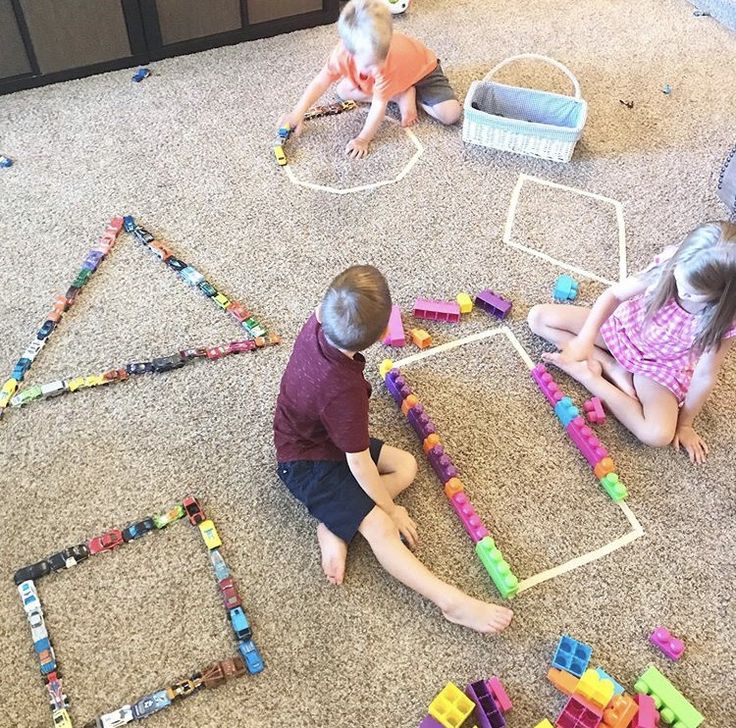 three children playing with toys on the floor