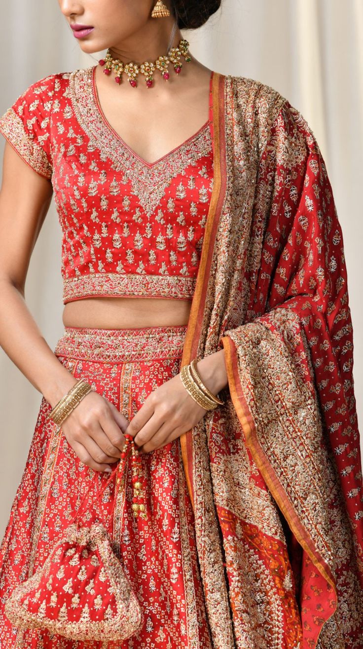 Editor's Note This set features a red & saffron paisley lehenga with blouse and dupatta. Neck: V-Neck Sleeve Type: Cap Sleeves Fabric: Silk Satin Care: Dry Clean Only About the Designer Ri Ritu Kumar is one of India’s foremost designers. She has developed a unique style of her own, reflecting the ancient traditions of Indian craftsmanship in a contemporary vocabulary. With a background in art history and museology, which has enriched her horizons, Ritu’s understanding of ancient designs and the Festive Red Cutdana Sets, Red Anarkali Set With Intricate Embroidery, Designer Red Set With Dupatta, Red Designer Wear Sets With Resham Embroidery, Transitional Season Red Raw Silk Sets, Anarkali Chandbali Red Sets, Transitional Red Raw Silk Sets, Festive Red Sets With Resham Embroidery, Designer Red Anarkali Set