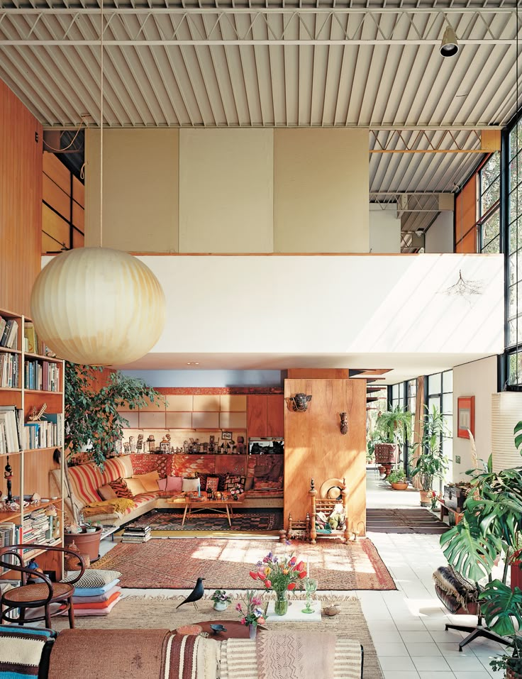 a living room filled with furniture and lots of books