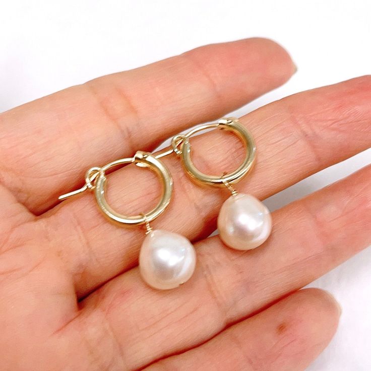 Petite huggie hoops featuring white fresh water pearls dangle. Gold filled hoops are 13mm in size. Genuine fresh water pearls are 9-10mm. Hypoallergenic Pearl Teardrop Hoop Earrings, Hypoallergenic Teardrop Pearl Hoop Earrings, Hypoallergenic Huggie Pearl Earrings, Pearl Charm Huggie Earrings, Pearl White Hoop Earrings With Pearl Drop, White Pearl Charm Hoop Earrings, Pearl White Dangle Hoop Earrings With Pearl Charm, White Pearl Hoop Earrings With Pearl Charm, White Pearl Hypoallergenic Hoop Earrings