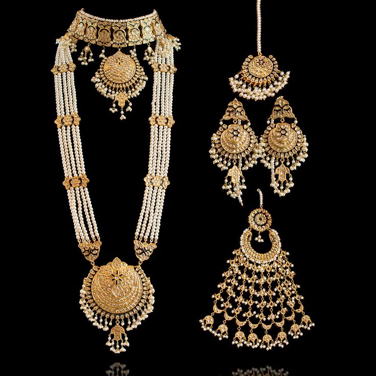 A set with the contemporary styling of traditional elements. If you want something exquisite and contemporary but also want to keep traditional feel alive, then our Mahra Set is the perfect choice! A beautiful set studded with kundan stones and adorned with black meenakari. Approximate mala length is 16.5". This bridal set includes a long mala paired with a choker, beautiful matching earrings and a maang teekah. Approximate earrings length is 3.5". This set is available in two options: Set with Luxury Chandbali Necklace For Wedding, Luxury Temple Jewelry Bridal Sets With Stone Work, Luxury Festive Mala With Meenakari, Luxury Meenakari Danglers For Formal Events, Luxury Gold Sets With Zari Weaving, Luxury Temple Jewelry Sets As Gifts, Luxury Temple Jewelry Sets With Intricate Design, Luxury Temple Jewelry Chandbalis For Ceremonial Occasions, Luxury Temple Jewelry Tikka With Zari Work