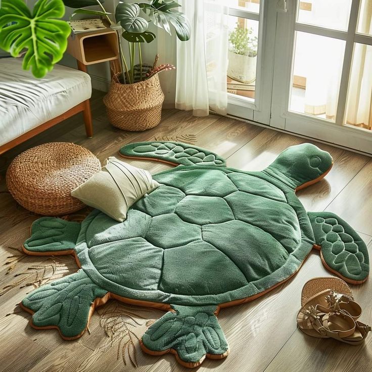 a green turtle rug sitting on top of a hard wood floor next to a window