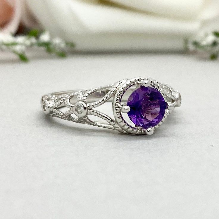 This beautiful ring is made from genuine 925 sterling silver with rhodium plating. Ring details- -The Main stone is a round cut 6mm Natural Amethyst -Side stones are Round Clear 1mm simulated diamonds -Ring is casted in solid 925 sterling silver with rhodium plating (yellow gold and rose gold plated also available, please check the drop down menu for more options) -The Total face height of the ring measures 10mms and the band width measures 2mms -Each ring is handmade and made to order, so pleas Heirloom Amethyst Solitaire Ring, Silver Halo Ring With Gemstone And Open Design, Silver Open Ring Halo With Gemstone, Silver Open Halo Ring With Gemstone, Heirloom Purple Ring With Center Stone, Sterling Silver Gemstone Halo Ring For Wedding, Silver Halo Ring With Birthstone For Formal Occasions, Silver Birthstone Ring With Gemstone For Wedding, White Gold Halo Ring With Gemstone For Promise