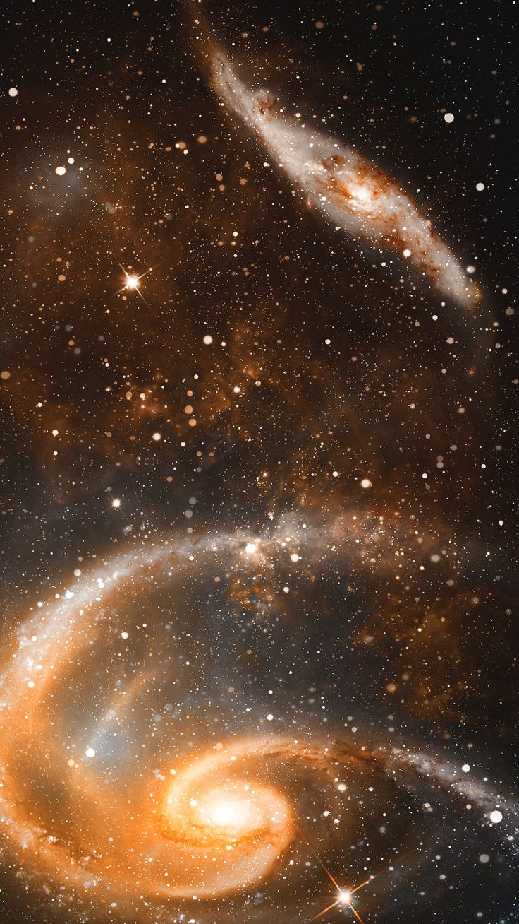 two spirally shaped objects in the middle of a space filled with stars and dust