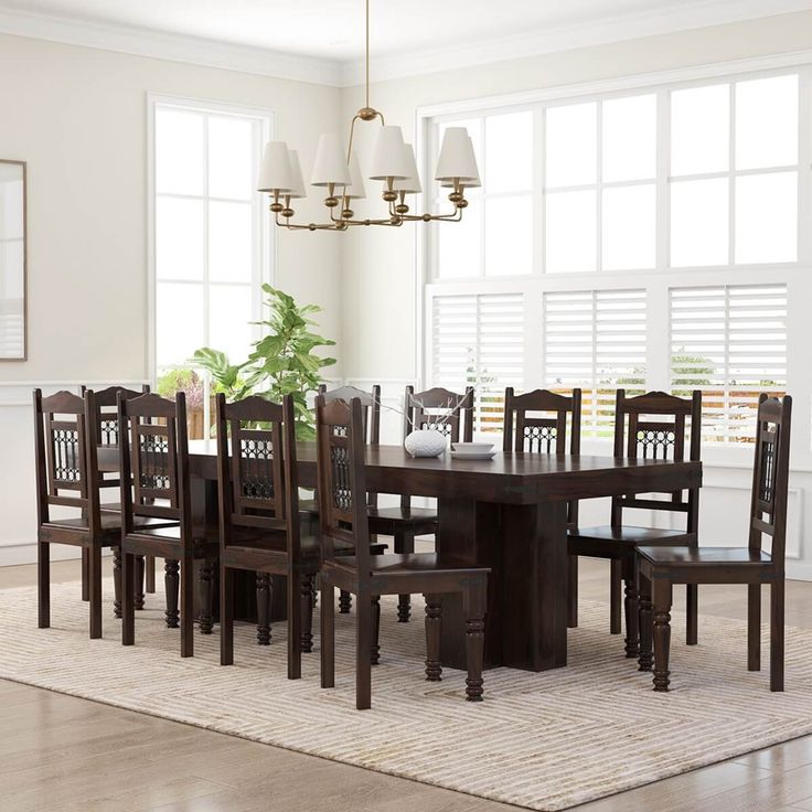 a dining room table with chairs and a potted plant