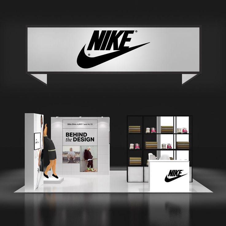 a woman standing in front of a nike store with the logo on it's wall