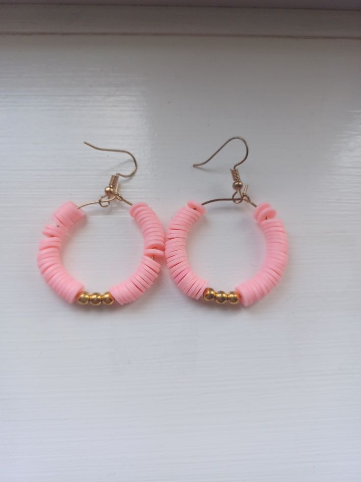 Pink clay bead hoop earrings with gold beads. Pink Earrings Diy, Cute Clay Bead Earring Ideas, How To Make Clay Bead Earrings, Clay Beads Earring Ideas, Beaded Pink Hoop Earrings For Beach, Pink Beaded Hoop Earrings For Beach, Pink Small Hoop Beaded Earrings With Dangling Beads, Pink Hoop Earrings With Dangling Beads, Pink Small Hoop Earrings With Dangling Beads