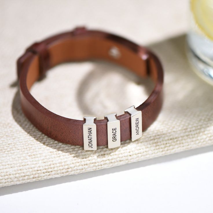 "Custom Made Men Jewelry Gifts for Him: Custom made engraved leather bracelet with names bead charms with black and brown leather. The perfect gift for him, dad, husband, boyfriend, mom, grandma, wife, sister, best friend or yourself. ✨✨ PERSONALIZED GIFT BOXES: https://www.etsy.com/listing/1066712740/mynamenecklace-personalized-gift-box ✨ SIZE & MATERIALS ✨ Material: Brown leather, Black leather Bead Material: Sterling Silver 925 Thickness: 5.8mm / 0.23\" Measurement: 15.24mm x 5.59mm / 0.6\" x Personalized Leather Bracelet For Friendship, Personalized Brown Leather Bracelet For Everyday, Everyday Leather Jewelry With Engraving Option, Personalized Silver Leather Bracelet, Personalized Silver Leather Jewelry, Adjustable Engraved Leather Bracelet, Personalized Leather Bracelet For Everyday, Adjustable Hand Stamped Leather Bracelet, Personalized Engraved Leather Jewelry