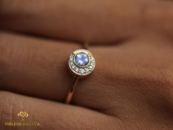 Moonstone engagement ring, Moonstone ring, Diamond engagement, Oval cut engagement ring, Rainbow moonstone ring, Anniversary gift for her Available in 9k/14k/18k yellow, rose or white gold. Same design can be made also with other custom gemstones per request. Product details: - Solid gold - Diamond - 1 to 1.2mm - Moonstone - 4mm (Top Quality) - Diamond clarity - VS , Color - F Ring size - US 3 to US 9 (for smaller or larger ring size, please contact) Please select your size at the drop down menu Gift Moonstone Ring With Halo Setting, Moonstone Promise Ring With Moon Phase, Moon Phase Diamond Rings As Gift, Dainty Moonstone Halo Ring, Round Celestial Moonstone Ring For Promise, Engagement Ring Moonstone, Moon Engagement Ring, Rainbow Moonstone Engagement Ring, Engagement Ring Round Cut