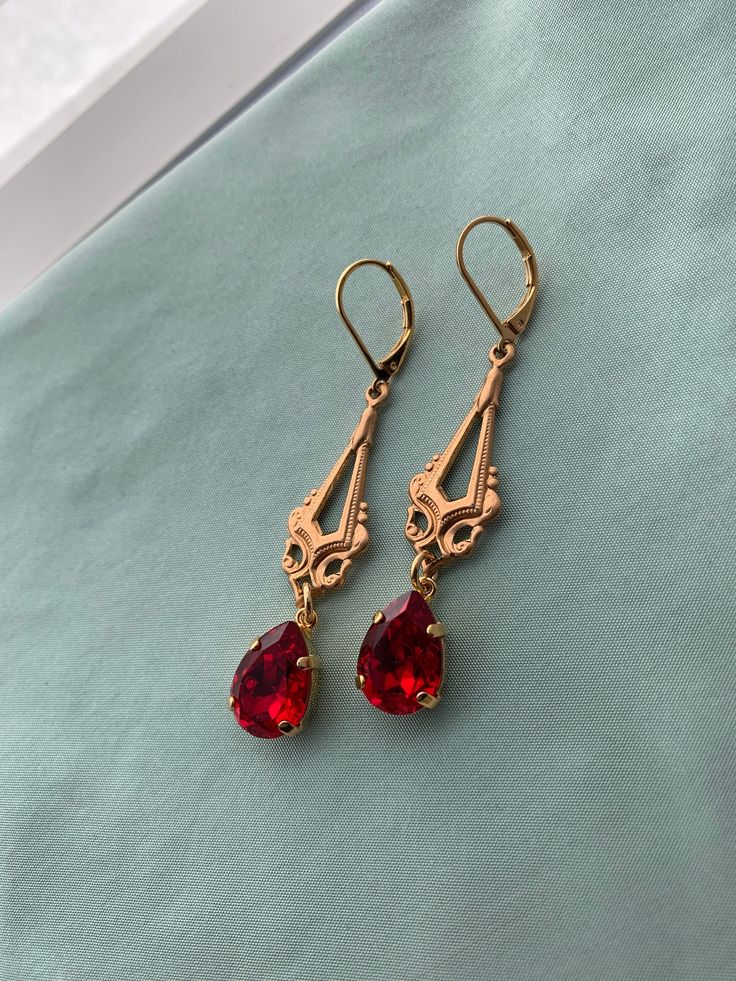 "RED Pear Edwardian Earrings in Swarovski Ruby or Scarlet Red Stones on 16k gold plated lever backs Long gold chandelier Edwardian earrings Pictures 1-3: SCARLET, Pictures 4-8: RUBY RED I do have some RUBY RED back in stock while supplies last! Ruby Red is a darker Red and slightly cooler tones, while Scarlet is a warm Red. This listing is for a pair of lovely reproduction Edwardian/Titanic style earrings. Gorgeous gold Edwardian chandeliers with RUBY RED or SCARLET RED Swarovski PEAR stones set Red Dangle Jewelry With French Hook, Elegant Red Dangle Clip-on Earrings, Red Chandelier Earrings For Anniversary, Elegant Red Teardrop Chandelier Earrings, Red Teardrop Chandelier Earrings For Formal Occasions, Gold Ruby Chandelier Earrings As Gift, Red Pear, Red Stones, Warm Red