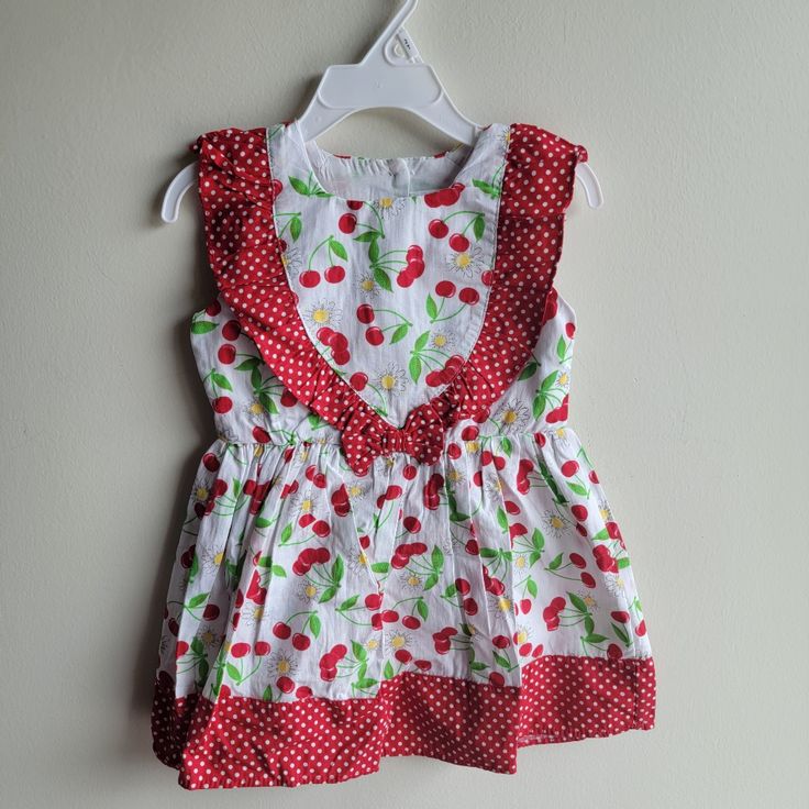 Nanette Dress Size 2t Cherries Design Ruffles Detail Sleeveless Red Ruffled Sleeveless Dress For Spring, Red Sleeveless Dress For Summer, Red Fitted Dress For Playdate, Cute White Cotton Sleeveless Dress, White Sleeveless Sundress For Dress-up, White Cotton Sleeveless Dress With Ruffles, White Sleeveless Dress With Ruffles For Dress-up, White Sleeveless Cotton Dress With Ruffles, Red Ruffled Dresses For Playtime