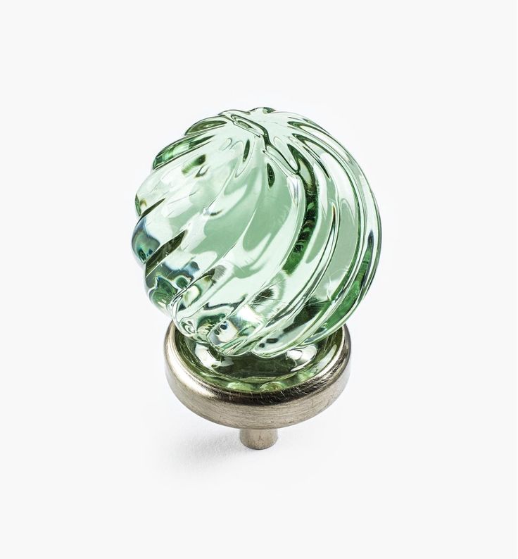 a green glass door knob on a white background