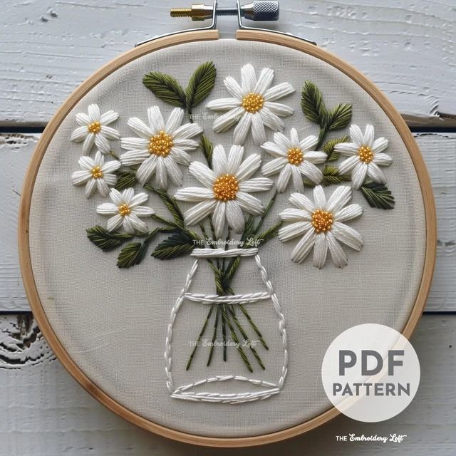 the embroidery pattern has daisies in a mason jar