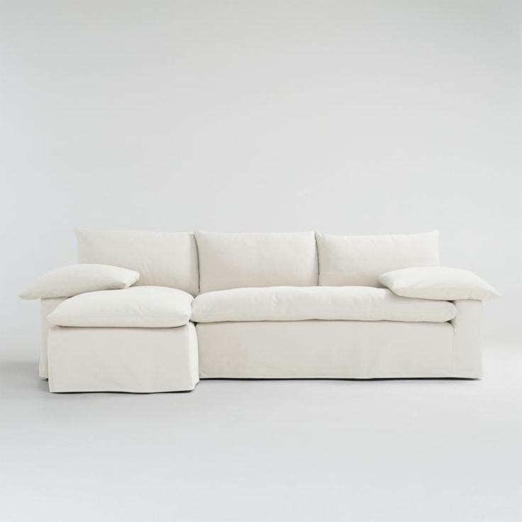 a white couch with pillows on it