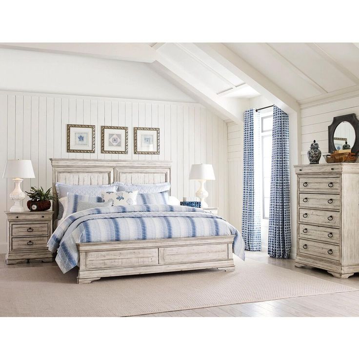 a white bedroom with blue and white decor