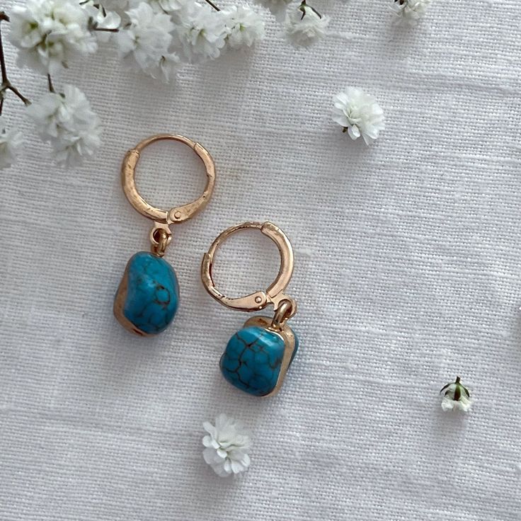 Turquoise Gold Encased Drop Earrings  ☾ ﾟ｡⋆ Details ⋆｡ ﾟ☾ Stone size: Approximately 1cm This listing is for one pair of earrings. The turquoise stones are excellent quality and absolutely stunning. Please note, the stones are organic in shape, as each is charmingly unique, she size and shape of each stone may vary. ☾ ﾟ｡⋆ How to care for your jewellery ⋆｡ ﾟ☾ Although our jewellery is made of high quality materials made to last, to ensure longevity we recommend the following care tips: ● Avoid showering, swimming, and exercising with our pieces ● Polish your pieces every 2 weeks or so, to increase shine and reduce discoloration ● Avoid wearing perfumes with your jewelry ● When not in use, store items in the pouch included in the order ☾ ﾟ｡⋆ Your future awaits ⋆｡ ﾟ☾ In every order, we include Adjustable Turquoise Earrings For Everyday, Elegant Everyday Turquoise Earrings, Elegant Turquoise Hypoallergenic Hoop Earrings, Elegant Turquoise Hoop Earrings, Blue Hypoallergenic Hoop Earrings As Gift, Blue Hypoallergenic Hoop Earrings For Gift, Blue Dangle Hoop Earrings As Gift, Blue Dangle Hoop Earrings For Gift, Nickel-free Blue Earrings As Gift For Her