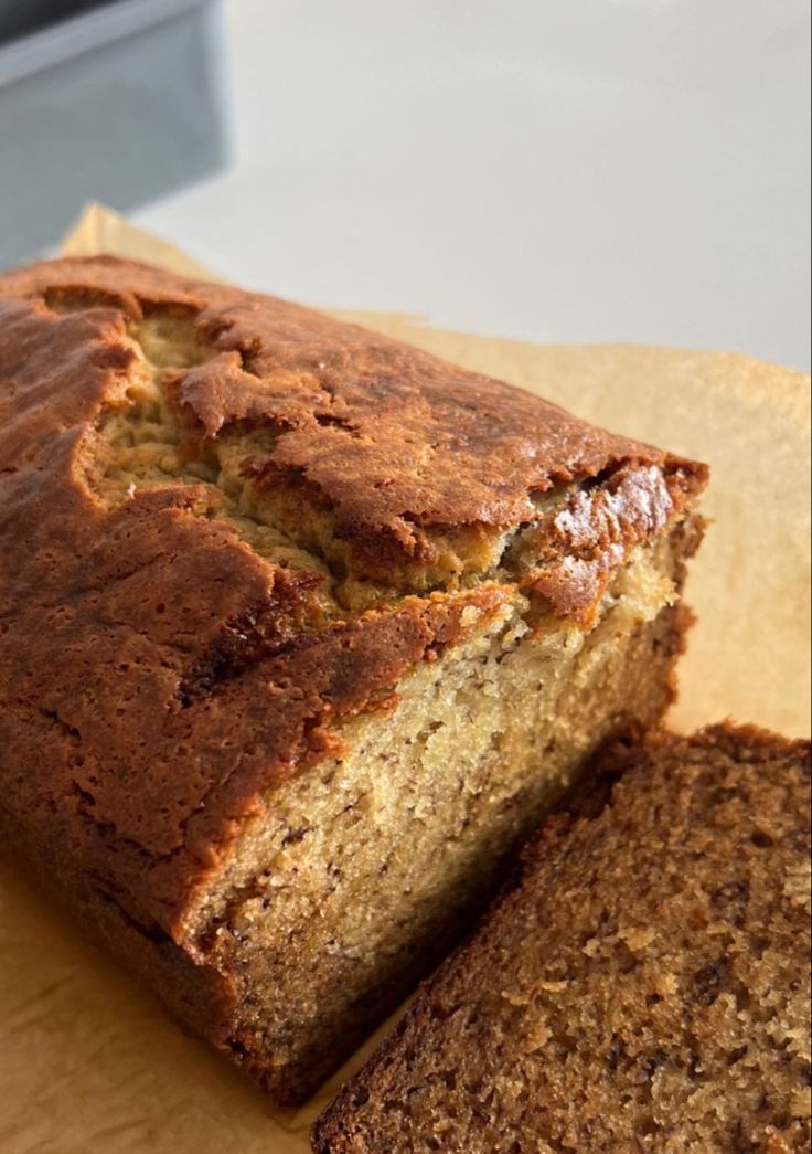 a loaf of banana bread sitting on top of a cutting board