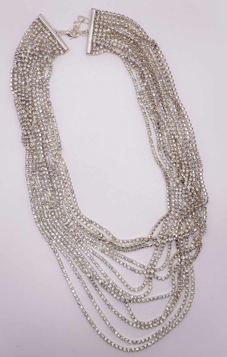 Add a touch of elegance and luxury to your attire with this multi-layered necklace. The intricate design features stunning faux diamonds set in white gold, creating a dazzling cascade of brilliance. Perfect for elevating your style with a blazer or dressing up your evening look in a cocktail dress, this necklace is a statement piece that exudes glamour and sophistication. Length: 11 inches + 4 inches extension Care: Avoid contact with water and cosmetics, such as creams or perfumes. To restore t Multi Layer Necklace, Lip Hair, Round Necklace, Sustainable Fashion Brands, Layered Necklace, Intricate Design, 11 Inches, Layered Necklaces, Set Dress