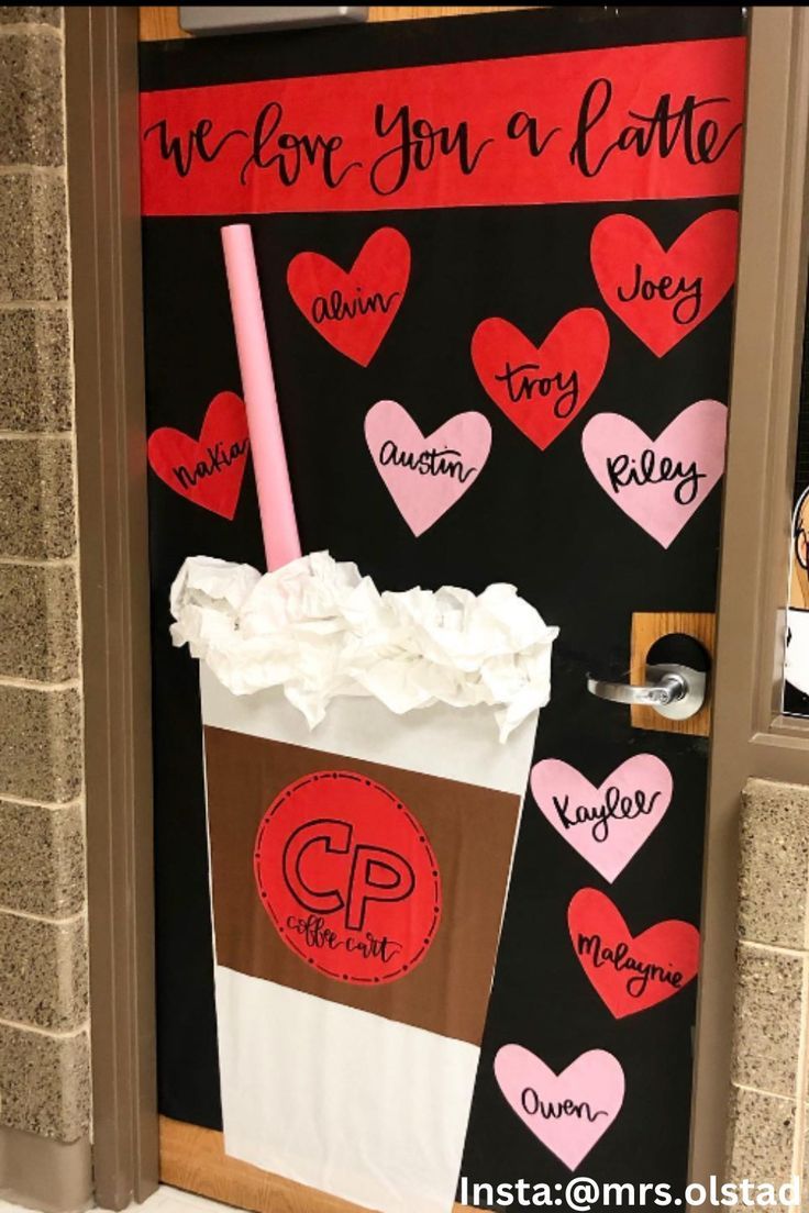 a door decorated with valentine's day decorations and paper heart cutouts, including a cup of coffee