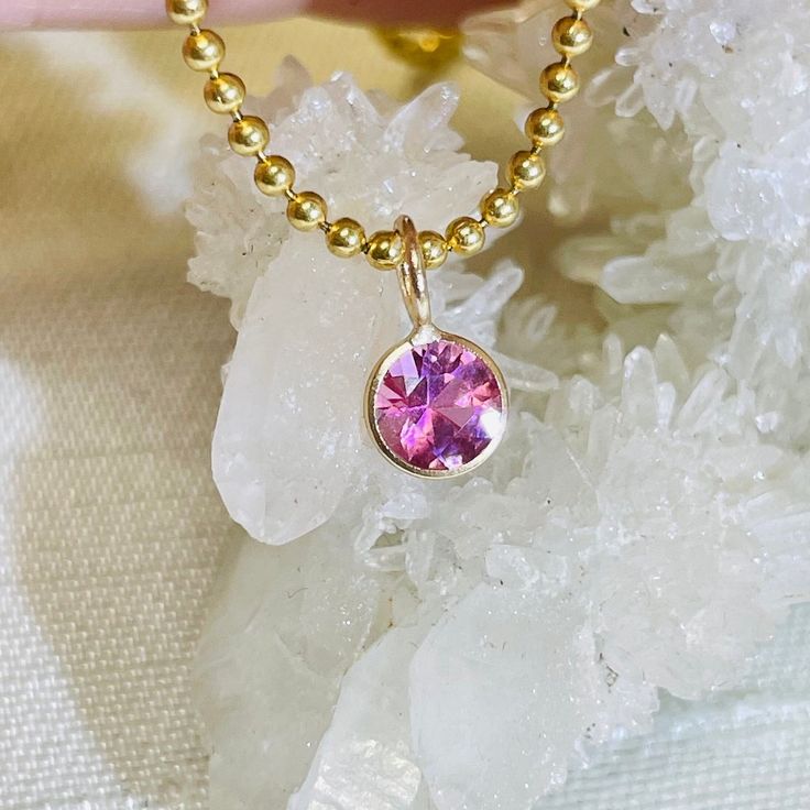 Featuring a natural and earthmined tourmaline with a gorgeous pink hue, and a round brilliant cut The fine gem is bezel wrapped solid 14K yellow gold with a round bail on top.  The bail has a 3mm inner diameter, round, but can be squeezed a little bit to make it more oval if necessary. The pendant is 9mm long x 6mm wide It can be worn alone or paired with another pendant. Gold Tourmaline Jewelry With Bezel Setting, Gold Jewelry With Round Cut Pink Sapphire, Pink Round Cut Tourmaline Jewelry, Pink Round Tourmaline Jewelry, Gold Jewelry With Pink Sapphire, Pink 14k Gold Round Cut Jewelry, Pink Faceted Tourmaline Jewelry, 14k Gold Pink Gemstone Jewelry, Pink 14k Gold Jewelry With Bezel Setting