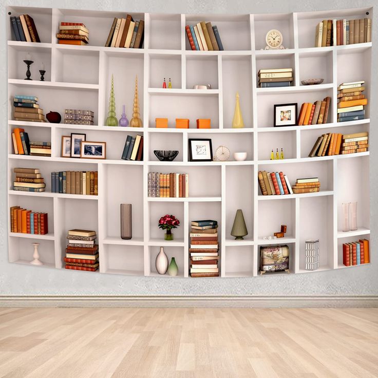 a white book shelf filled with lots of books on top of a hard wood floor